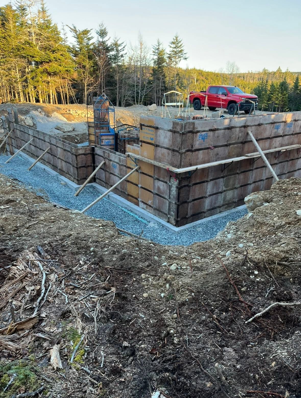 Concrete foundation wall forms with a work truck on site